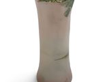 a vase with a plant in it on a white surface