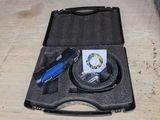 a tool in the case on the floor next to other tools