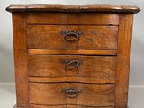 une vieille commode en bois comportant trois tiroirs de chaque côté