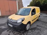 the small yellow van is parked in the parking lot