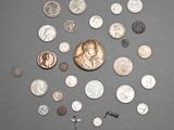 a lot of coins and a penny on a table