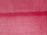 a close up of a piece of pink fabric with a hole in the middle