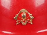 a red fireman ' s helmet with a gold emblem on it