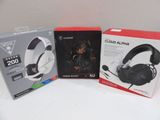 two boxes of headphones are sitting on a table next to each other