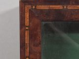 a wooden frame with a mirror on the wall