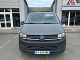 the front view of a black vw van parked in a parking lot