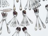 a lot of silver spoons and forks arranged in a circle