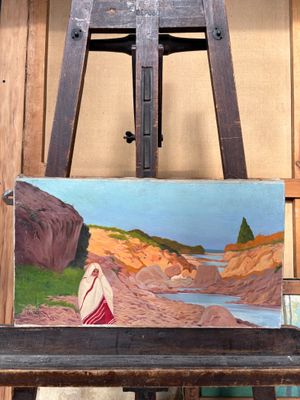 un tableau posé sur un chevalet représentant une femme en robe rouge