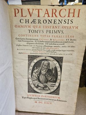 an old book with a picture of a woman holding a baby