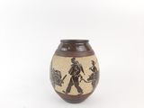 a brown vase with a black and white design on it