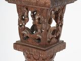 carvings on the top of the table are carved to look like elephants