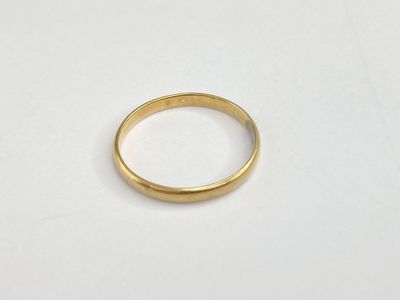 a close up of a gold ring on a white surface