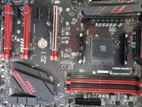 a close up of a computer mother board with red and black parts