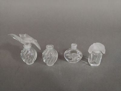 three small glass bottles sitting on top of a table next to each other