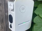 a white electronic device that is on the side of a fence