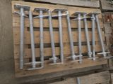 four bolts and two screws on a wooden pallet