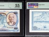 two pieces of paper money with a picture of a mountain in the background