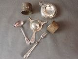 five spoons, a teapot, and a measuring spoon on a table