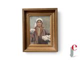 tableau représentant une femme tenant un bouquet de fleurs, dans un cadre doré