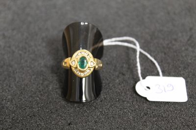 une bague sertie d'une pierre verte et munie d'une étiquette de prix