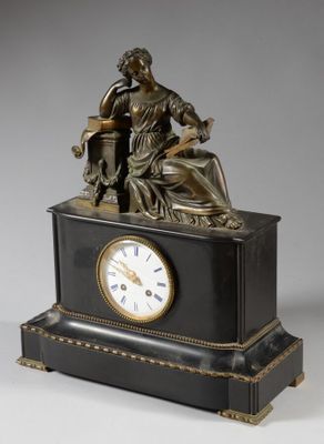 a statue of a woman sitting on a table with a clock