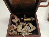 a small wooden box with a brass sexet inside of it