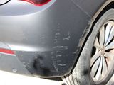 a close up of a car ' s rear end with a tire