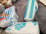 a cardboard box full of diapers and a stuffed animal