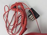 a red cord that is connected to a red telephone