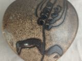 a heart shaped stone with a picture of a deer on it