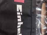 the back of a black jacket with a red and white logo on it