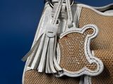 a brown bag with a tassel hanging from it ' s handle