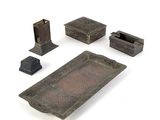 four pieces of metal that are sitting on a white surface