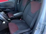the interior of a car with the door open and the driver ' s seat up