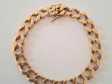 an image of a gold bracelet on a white surface