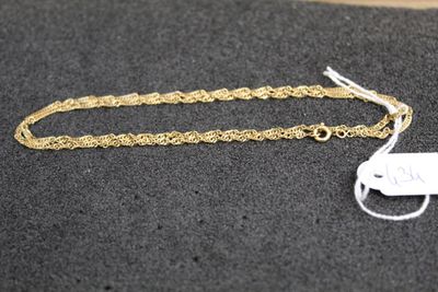 a close up of a gold chain with a tag on it