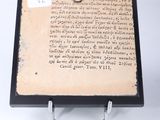 a piece of paper with writing on it sitting on a stand