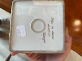 someone is holding a ring dish in their hand with a price tag on it