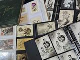 a lot of old photos in a binder on a table