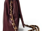 a brown purse with a chain hanging from it ' s side