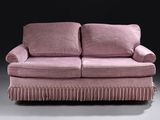 a pink couch that is sitting in a room