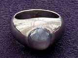 silver ring with a blue stone in the middle of it