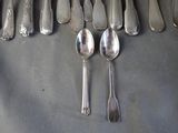 a lot of silver spoons and spoon spoons on a table
