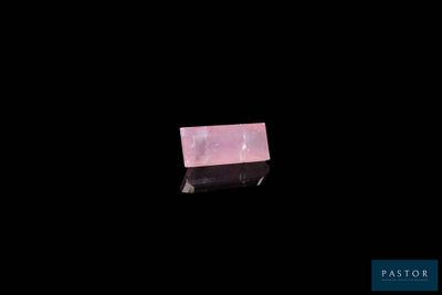 an image of a piece of pink quartz on a black background