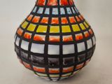 a vase with a colorful design on it on a table