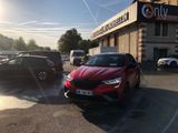 a red car parked in front of a building