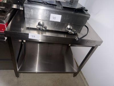 stainless steel counter top with two deep fryers on top of it