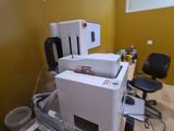 a white printer sitting on top of a desk in a room