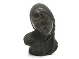 a small statue of a woman holding a dog