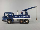 a toy truck with a crane attached to it ' s back
